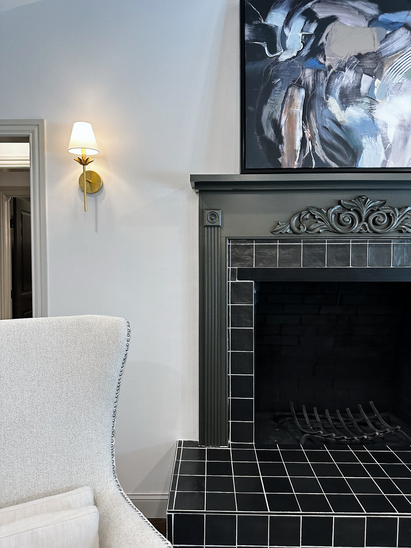 Hand-tiled fireplace with abstract painting